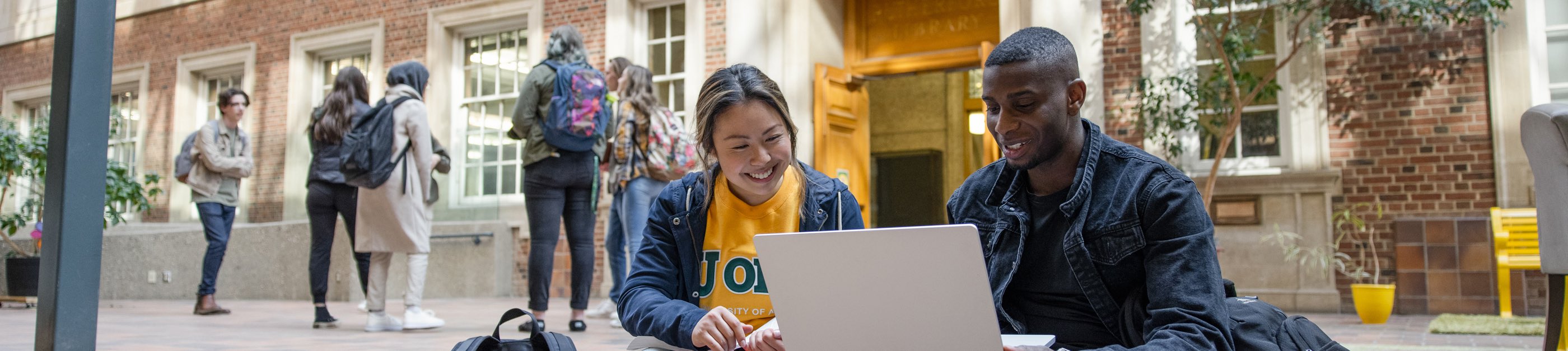 Two arts students on the steps in Rutherford Library