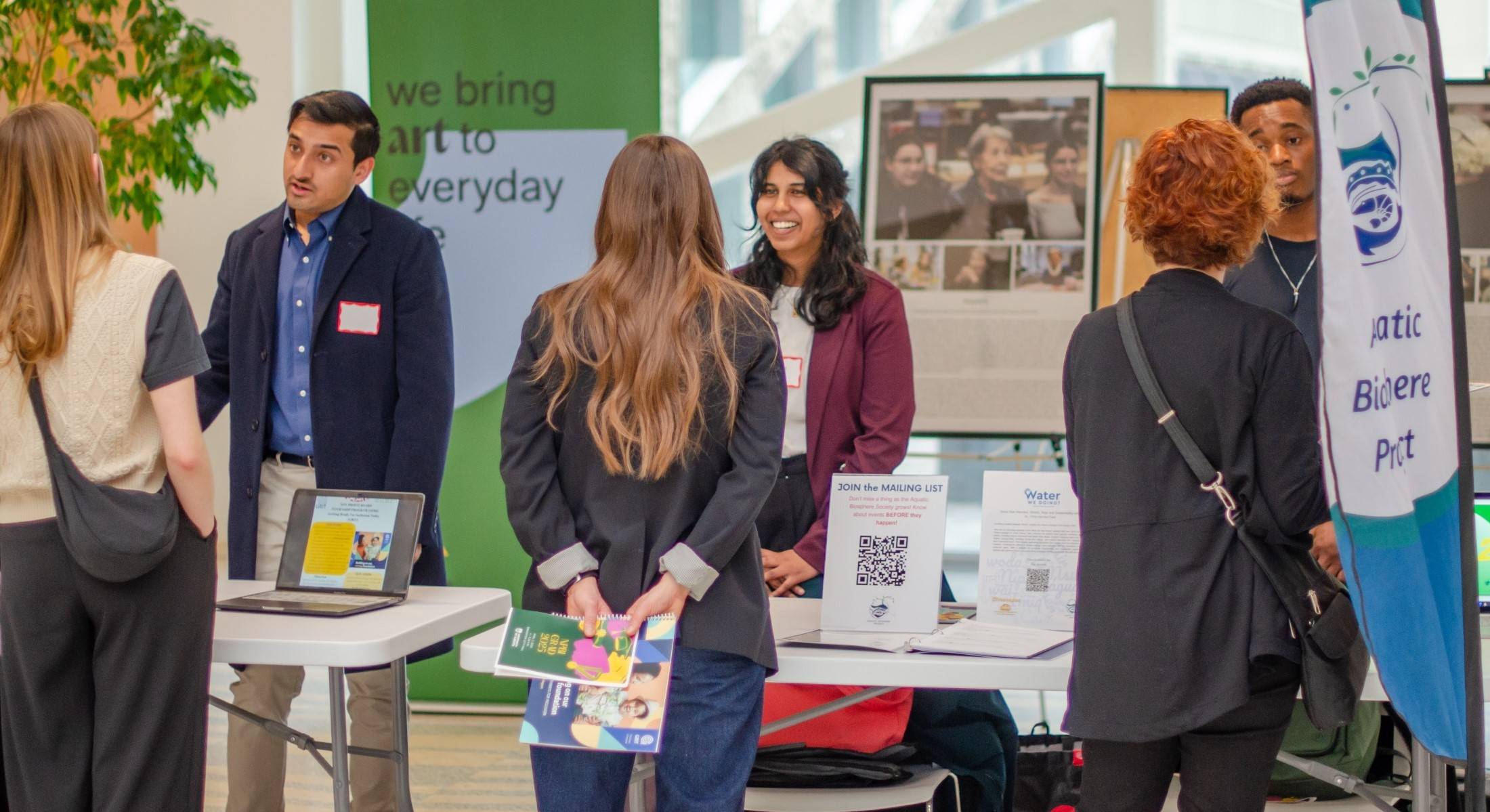 Recruitment booths with people conversing
