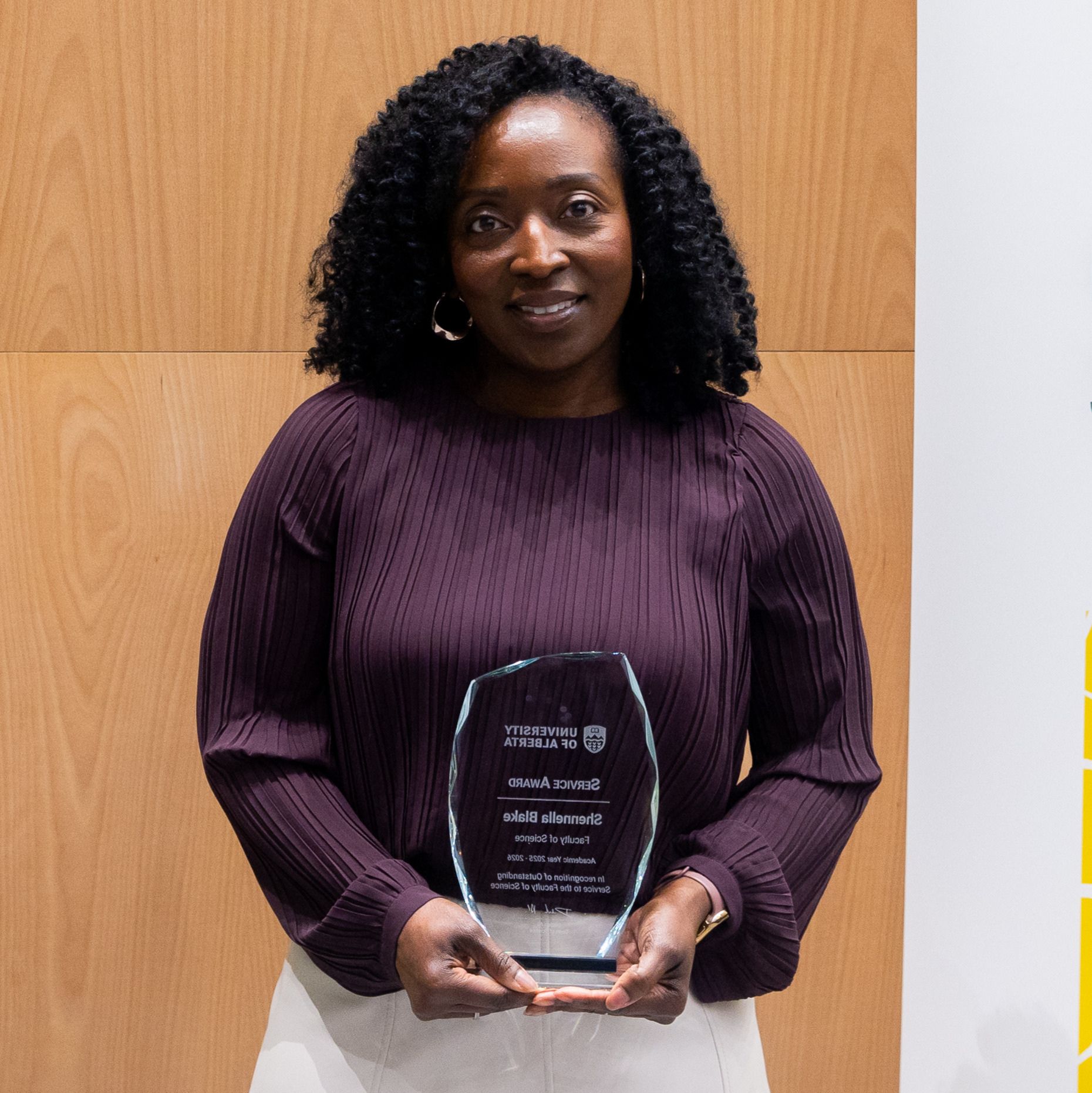 Photo of Shennella Blake receiving an award at the 2026 Celebration of Excellence.